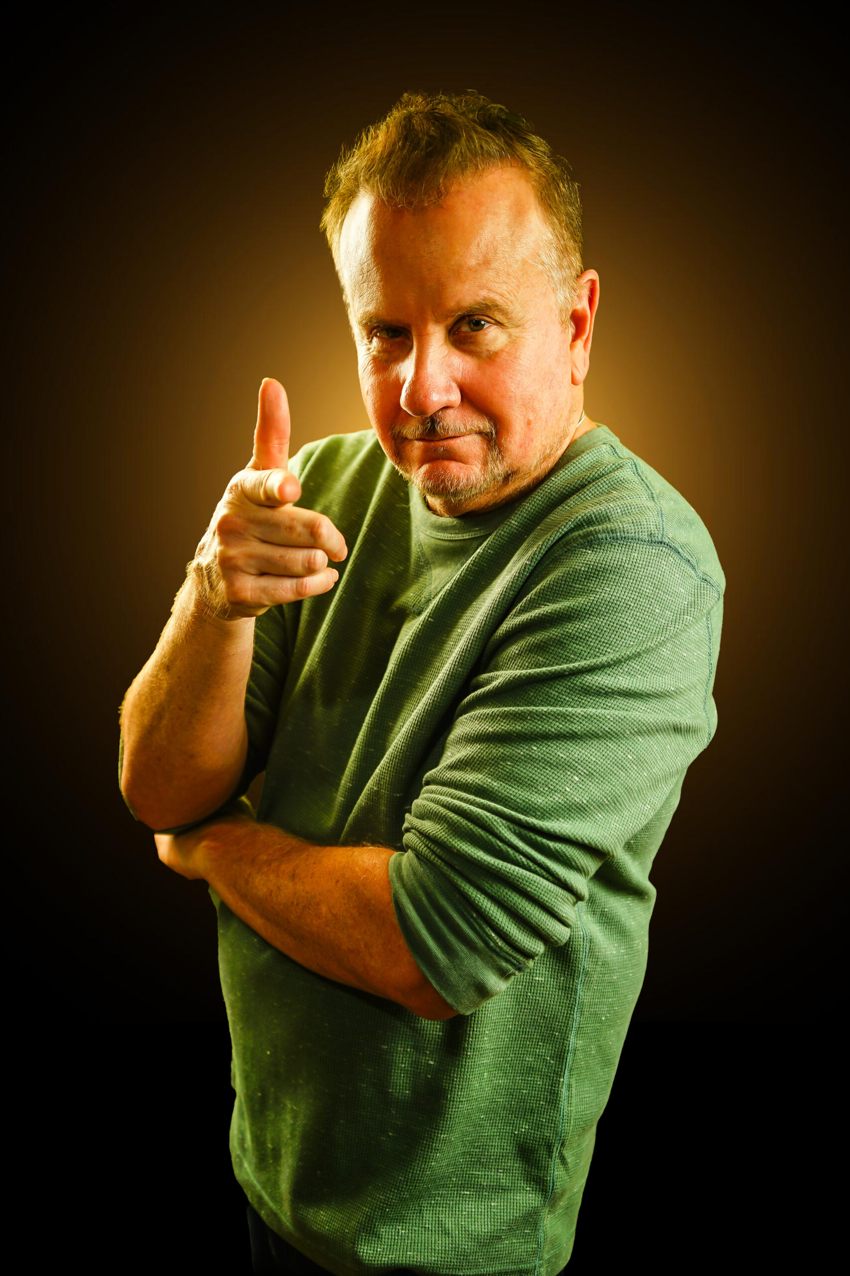 Stand-up comedian Mike Rivera in a green shirt